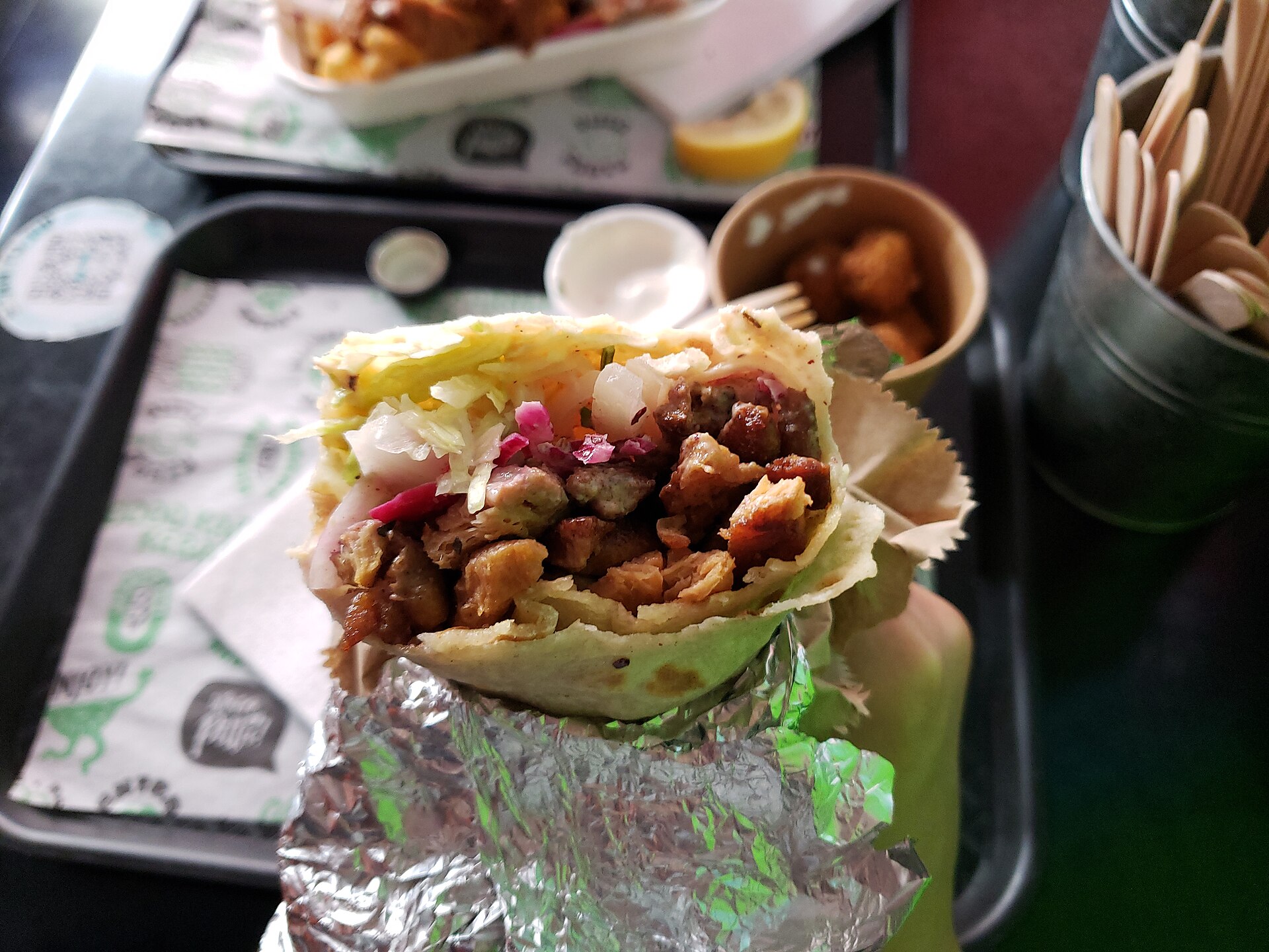 Kebab w lawaszu, przekrojony, z mięsem, kapustą i czerwoną cebulą